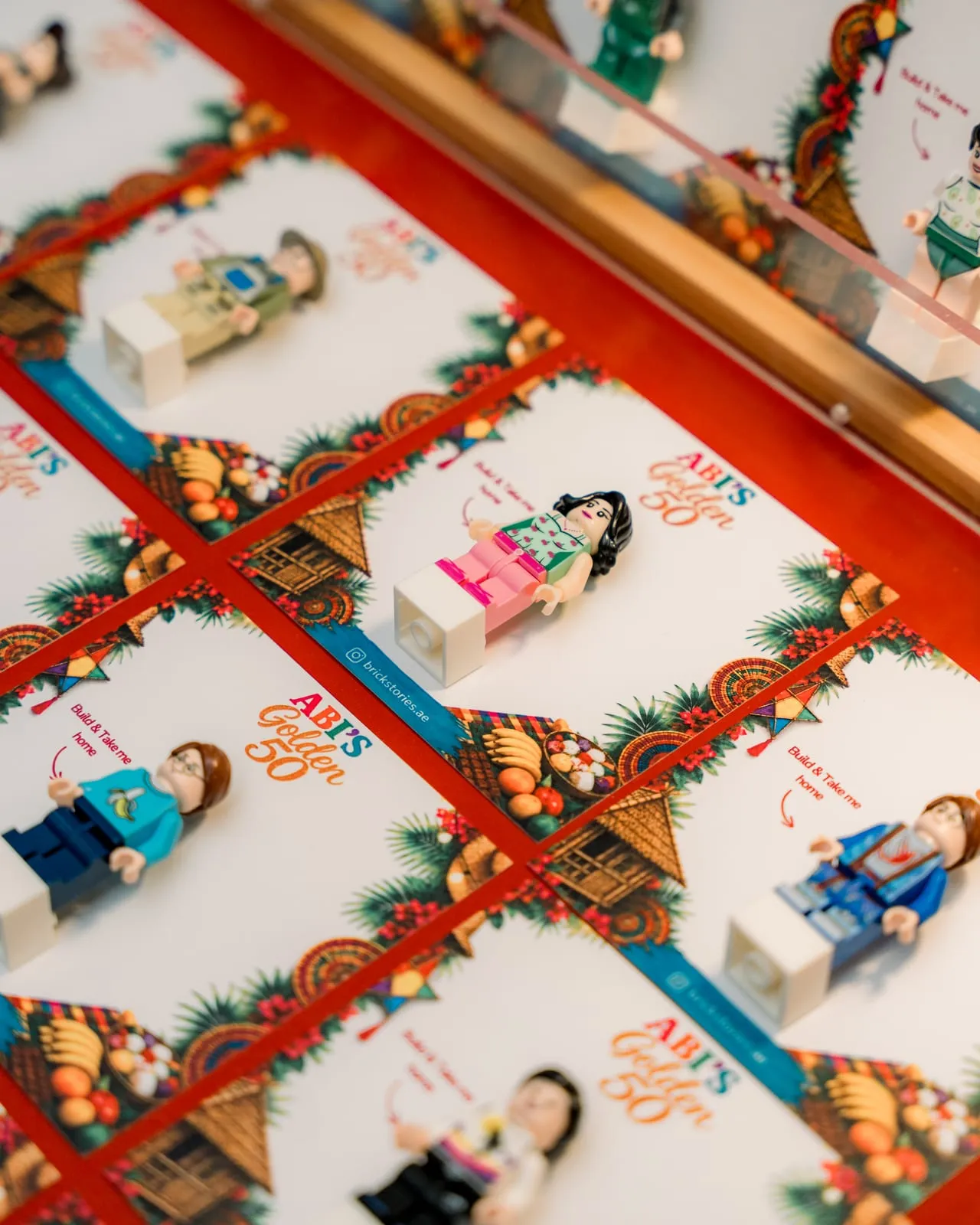 Rows of mini figures on backing cards custom designed for a 50th birthday in Dubai