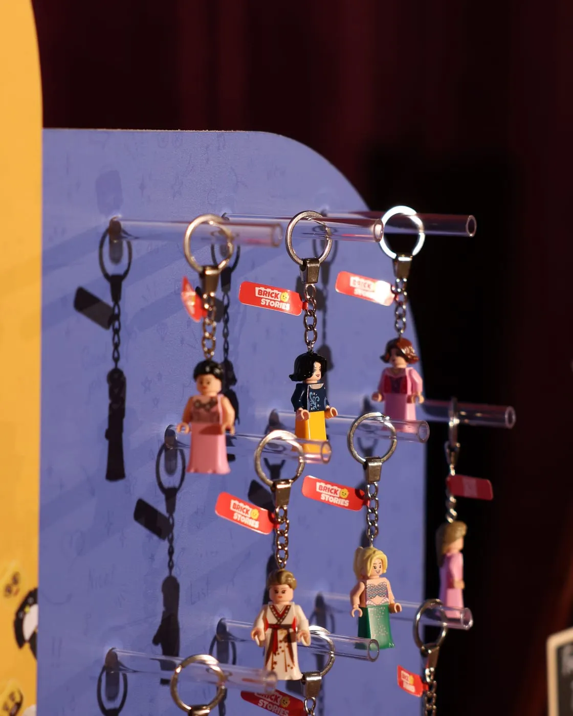 Finished mini figure keychains hanging on the display, ready to be taken home