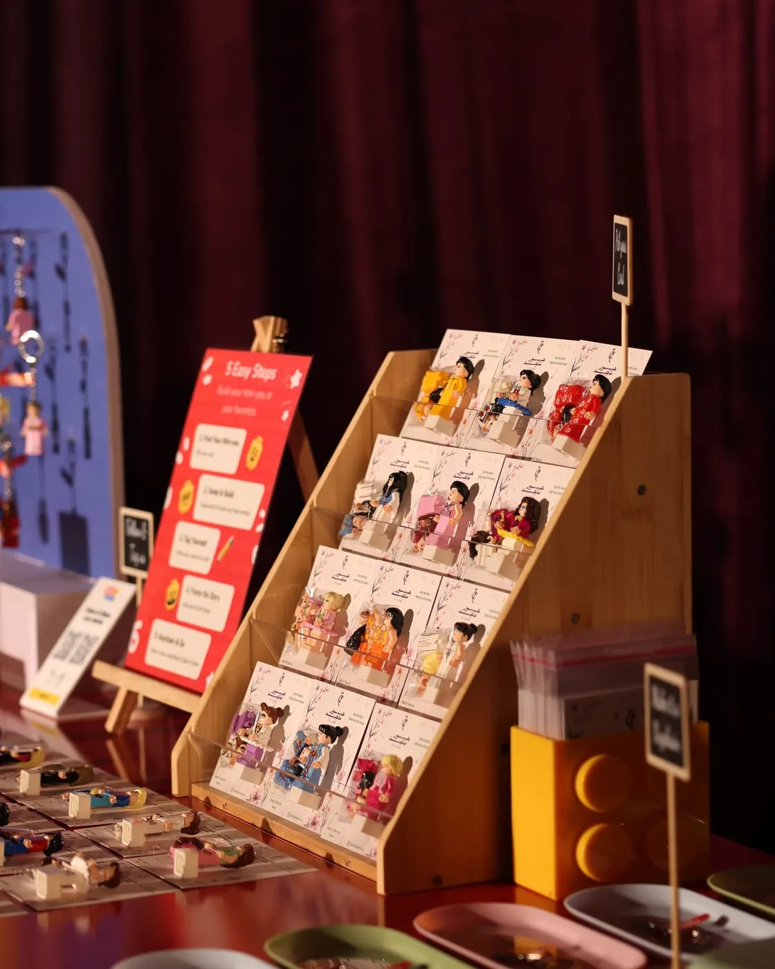 Tiered stands of personalised mini figures on backing cards at a wedding in Sharjah