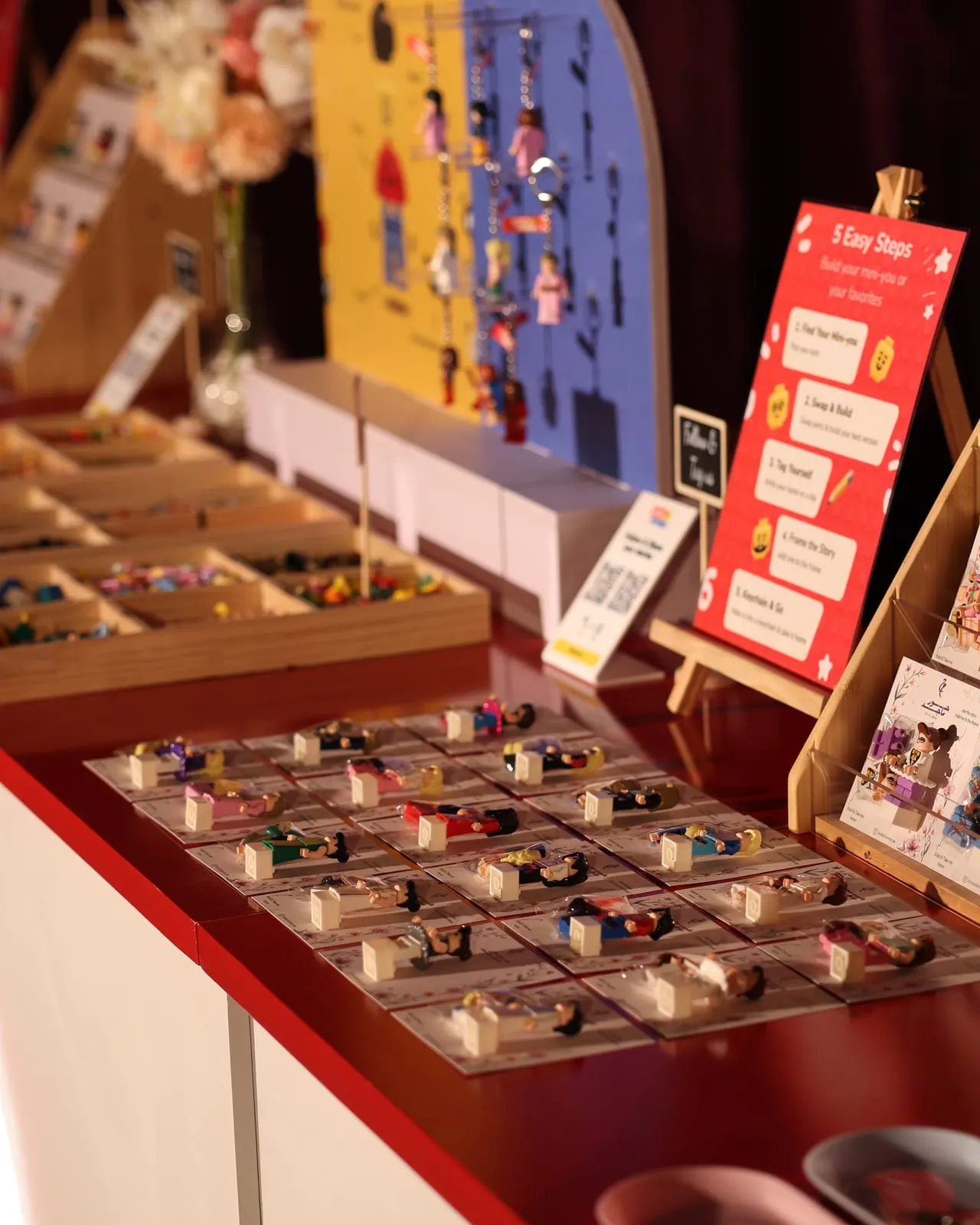 A styled mini figure display with signage and figure stands at a wedding in Sharjah