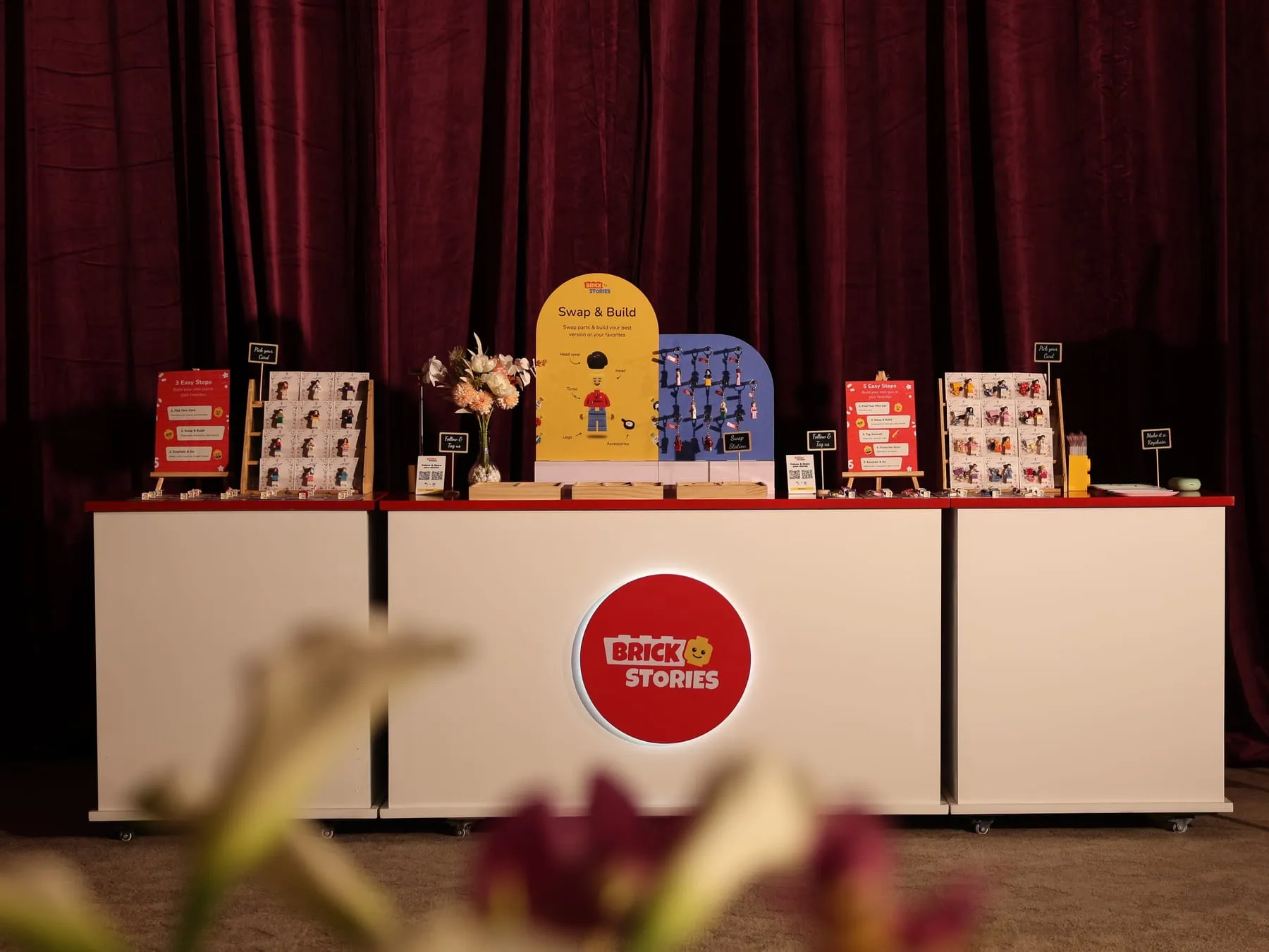 The Brick Stories booth set up at a wedding in Sharjah, with the Swap & Build display on the counter
